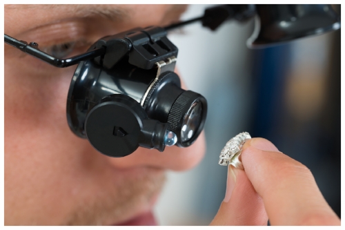 Qualified Jeweler Inspecting to See if a Diamond is Real