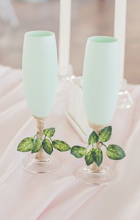 Seafoam green cocktail and champagne glasses with greenery