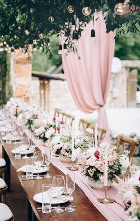 Rustic dusty rose outdoor wedding reception with place settings and chiffon table runner