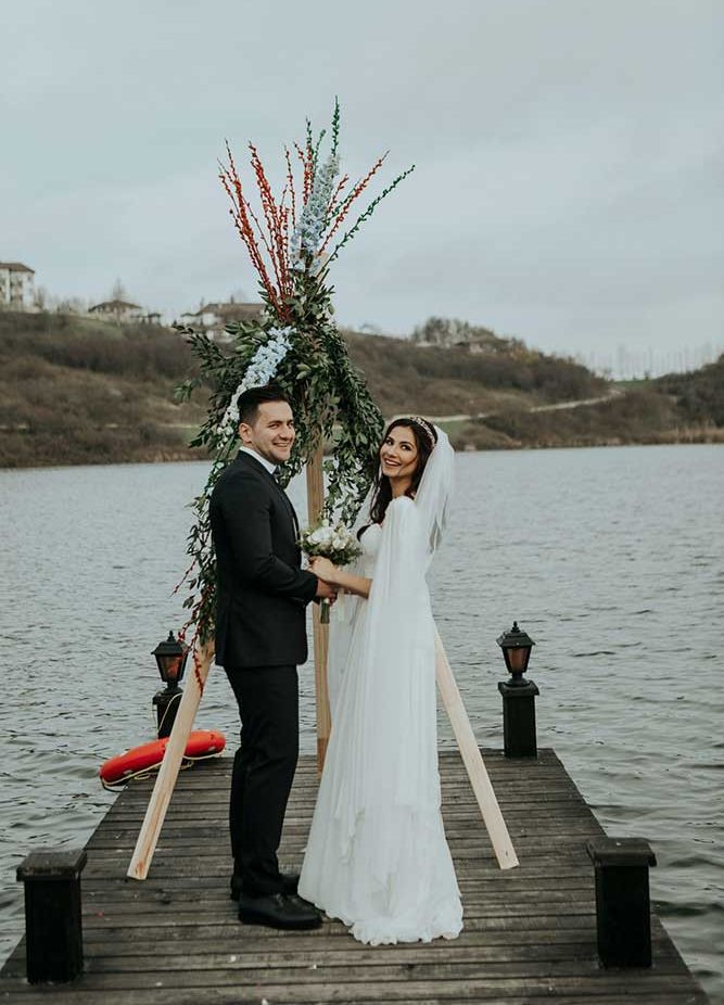 bride and groom getting married on the lake
