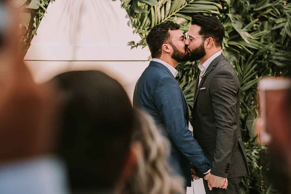 gay couple kissing on their wedding day
