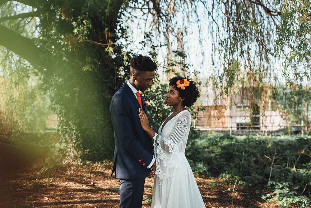 Bride and groom eloping under a tree on their wedding day
