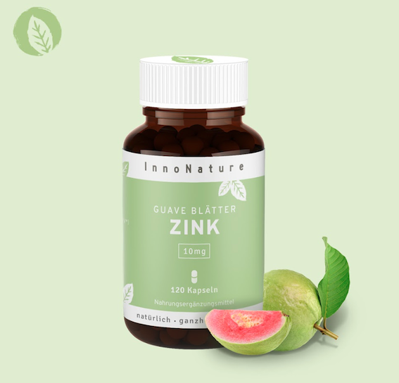 Zink-Kapsel Dose von InnoNature vor mintfarbenem Hintergrund. Daneben ist eine Guavenfrucht zu sehen.