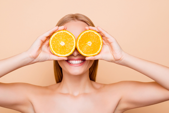 blonde-frau-mit-zitrusfrucht-vor-den-augen-fuer-ein-starkes-immunsystem