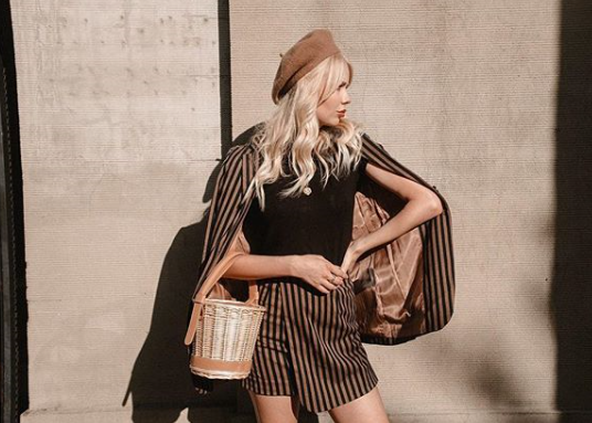 Girl wearing striped black and brown blazer skirt set called Virginia by J.ING women's fashions