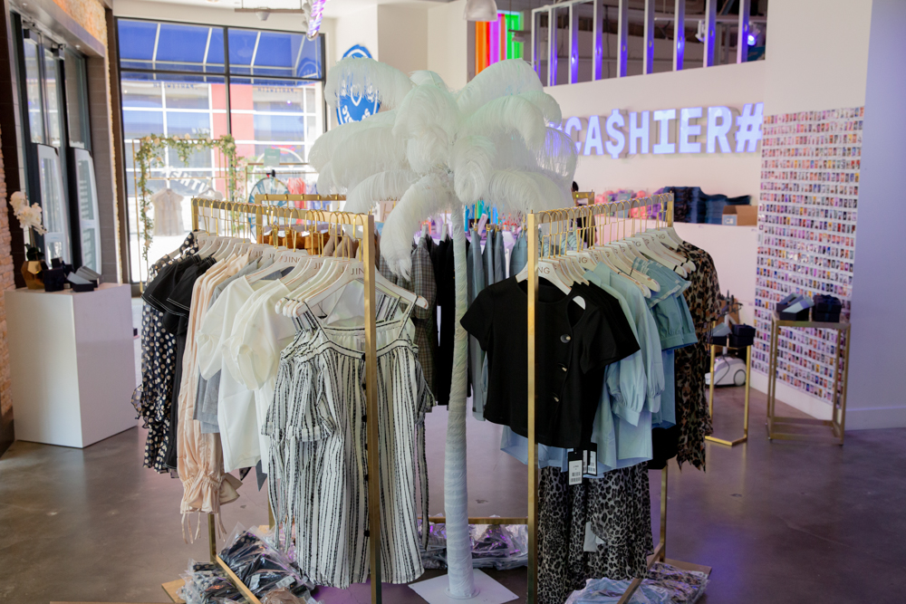 j.ing la women's fashions displayed on racks