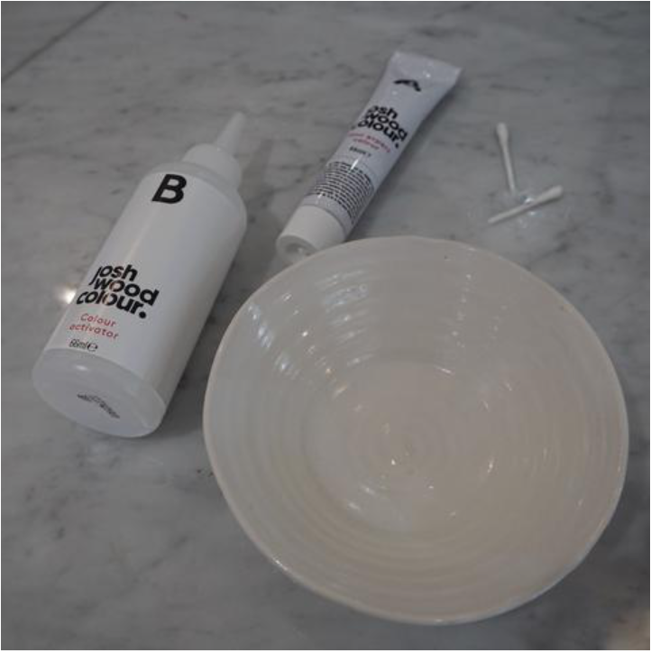 A white bowl with a tube of hair dye and a bottle of developer - Josh Wood Hair Colour Expert