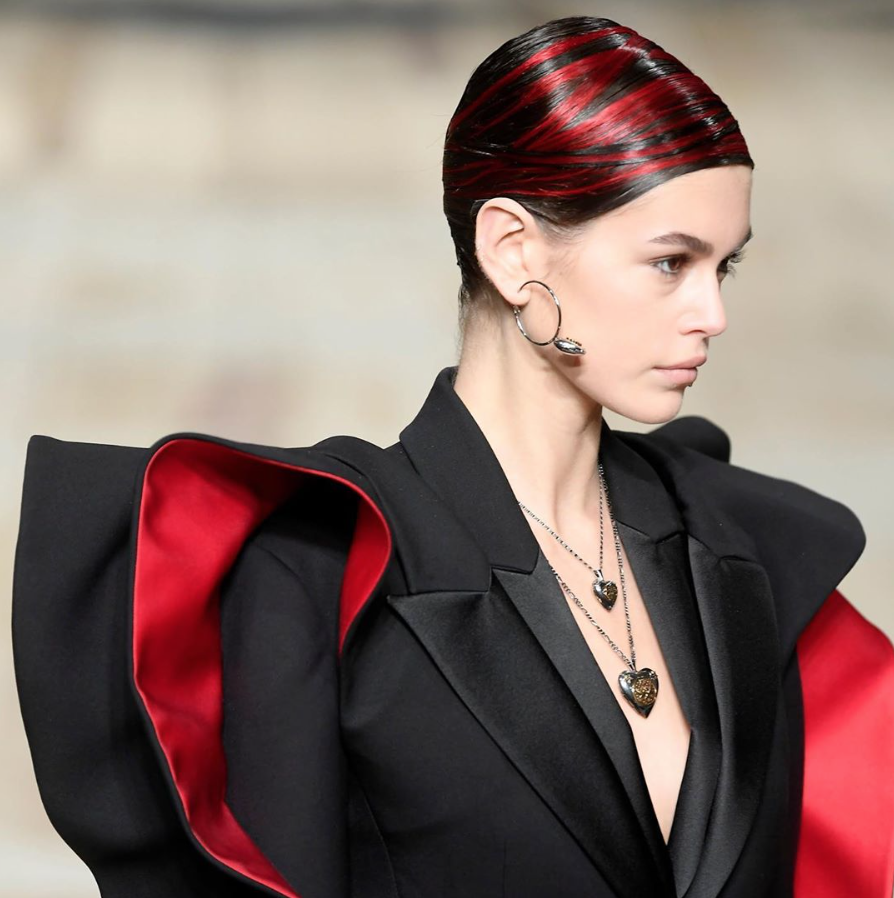 A model wearing a black suit and red hair on the runway - Josh Wood Hair Colour Expert