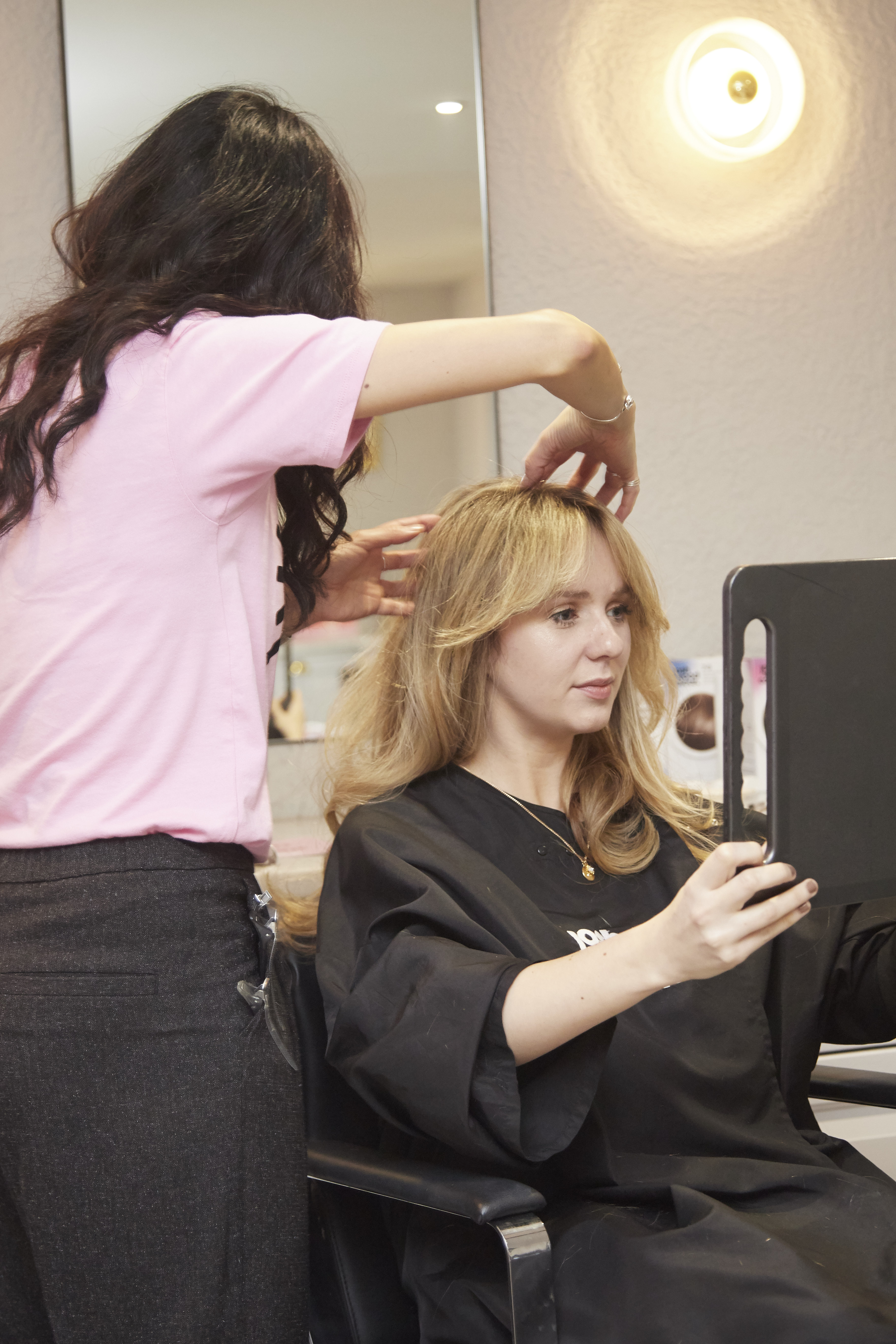 A woman is getting her hair cut - Josh Wood Hair Colour Expert