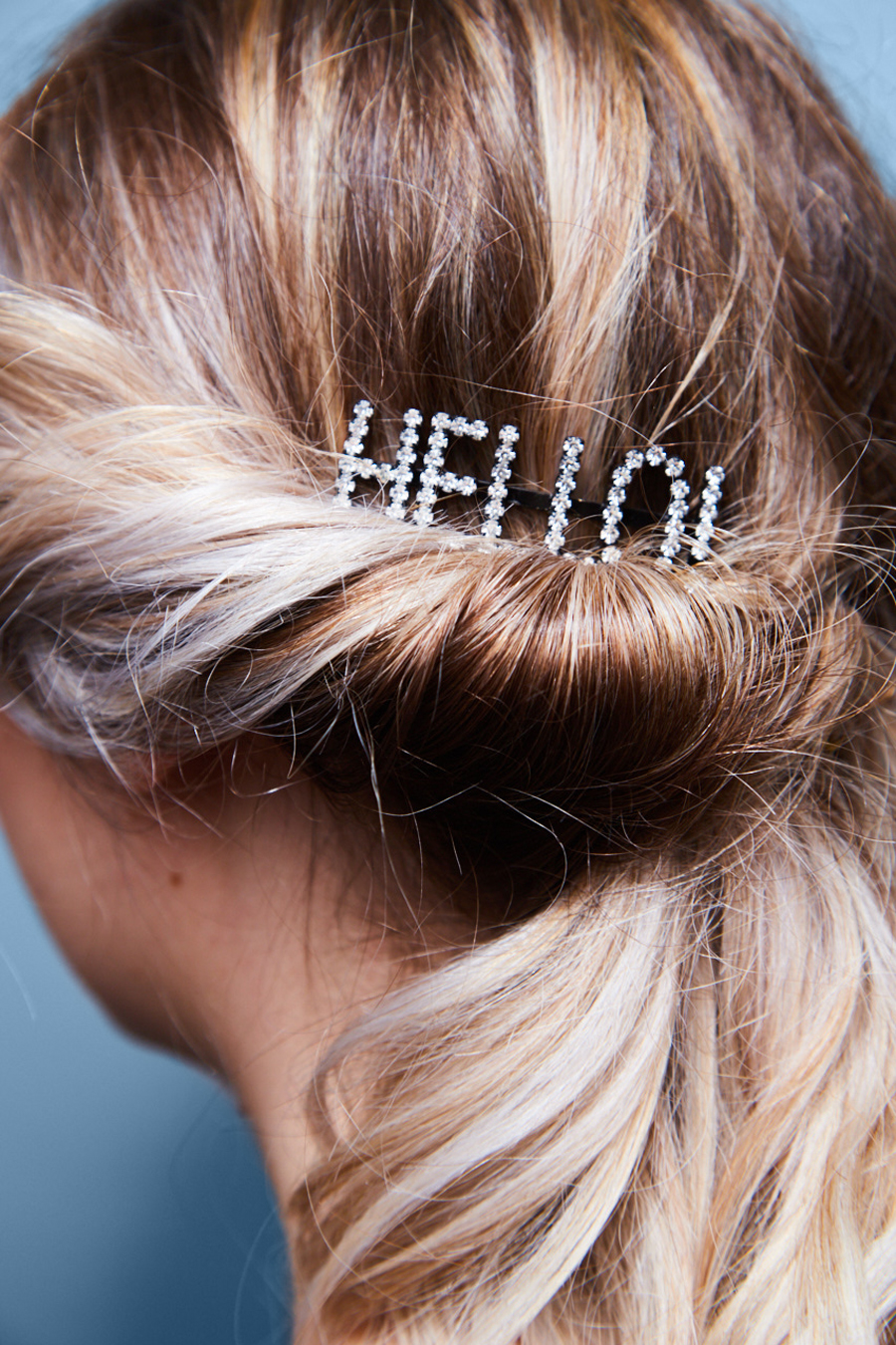 A woman's hair with a hair clip that says hello - Josh Wood Hair Colour Expert