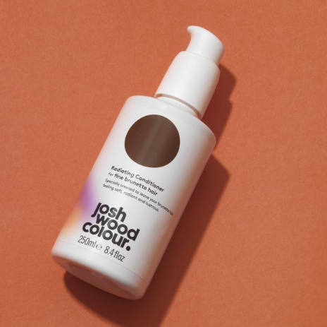 A bottle of hair colour on an orange background - Josh Wood Hair Colour Expert