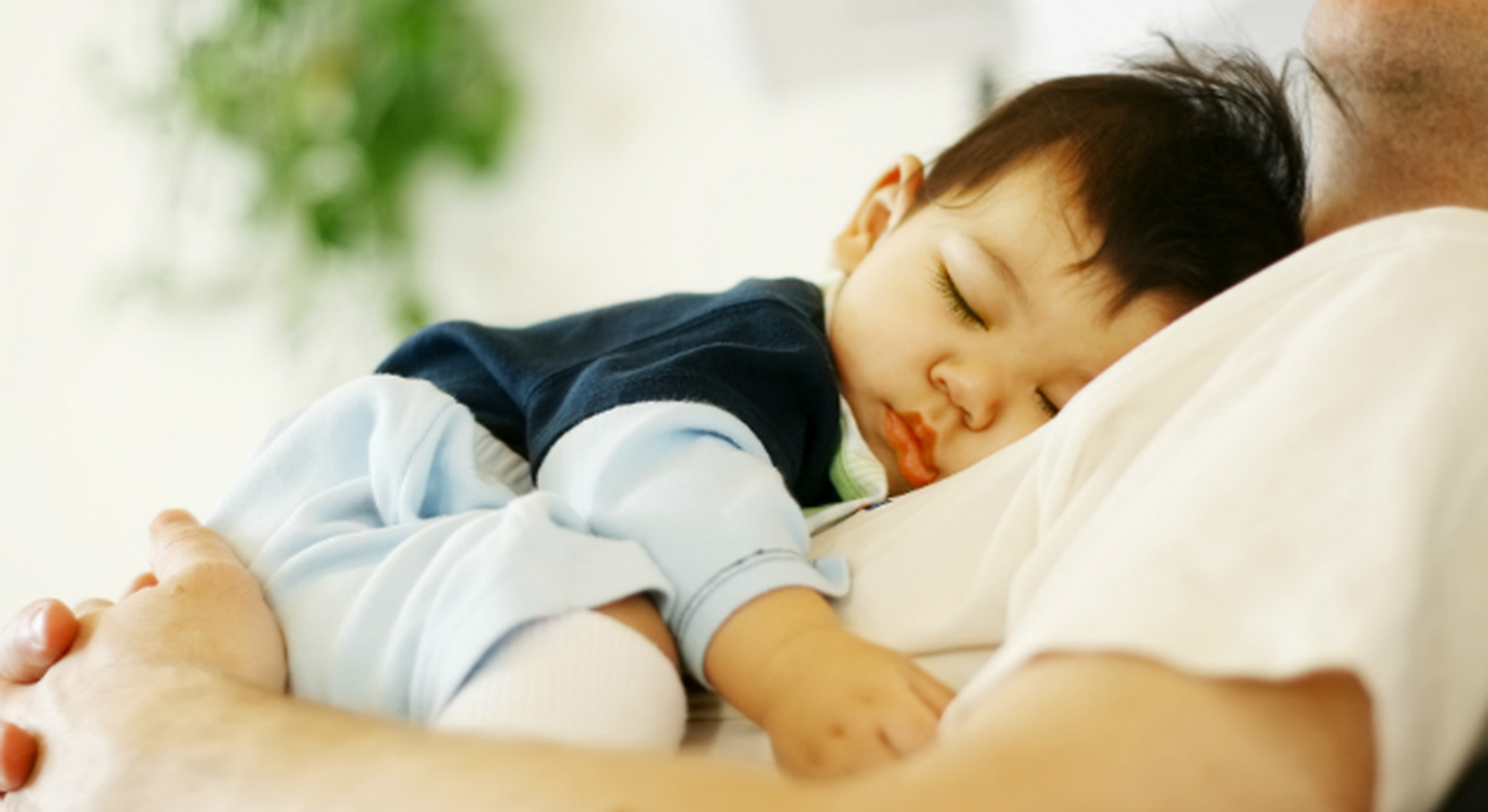 baby boy asleep on dad's chest