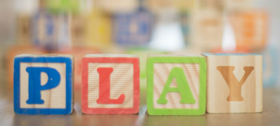 Wooden letters spell the word 'Play'