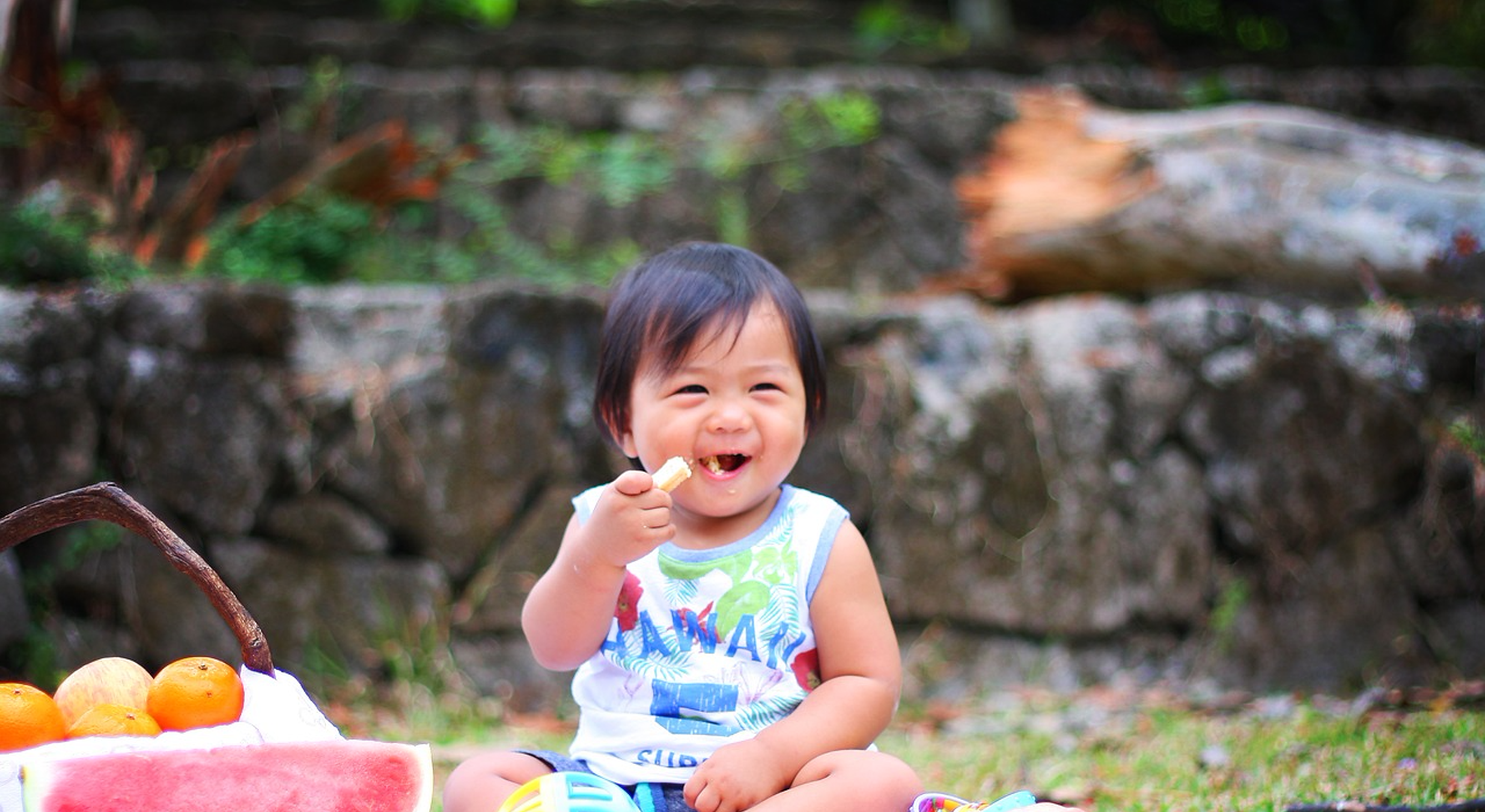 Toddler eating snacks outdoors