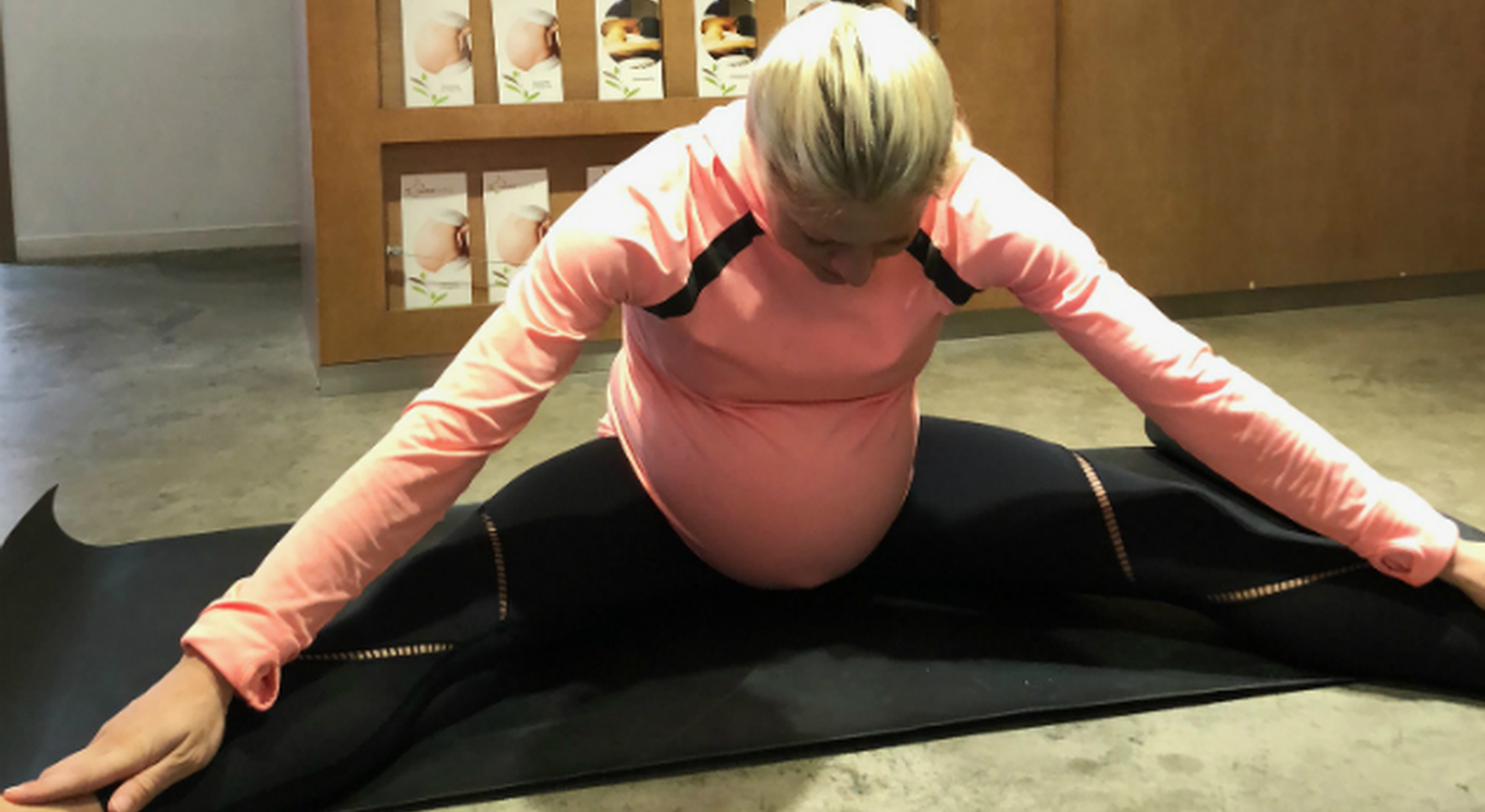 Pregnant woman performing adductor stretches