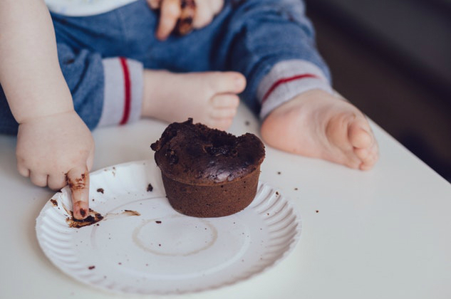 Kid playing with chocolate cake