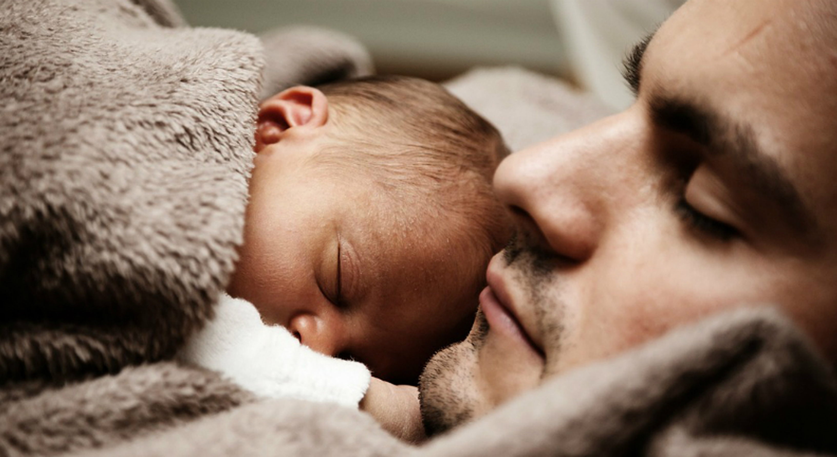 Dad and newborn sleeping