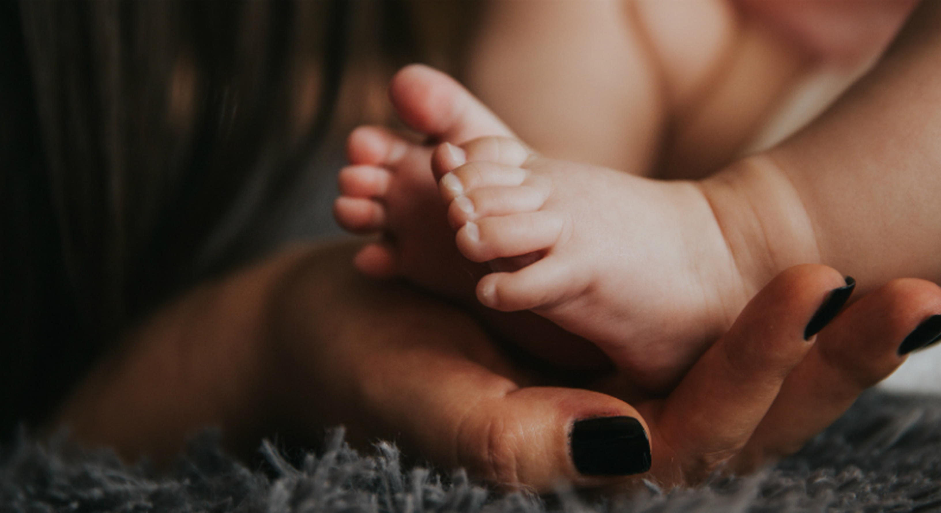 depressed mom holding baby's feet