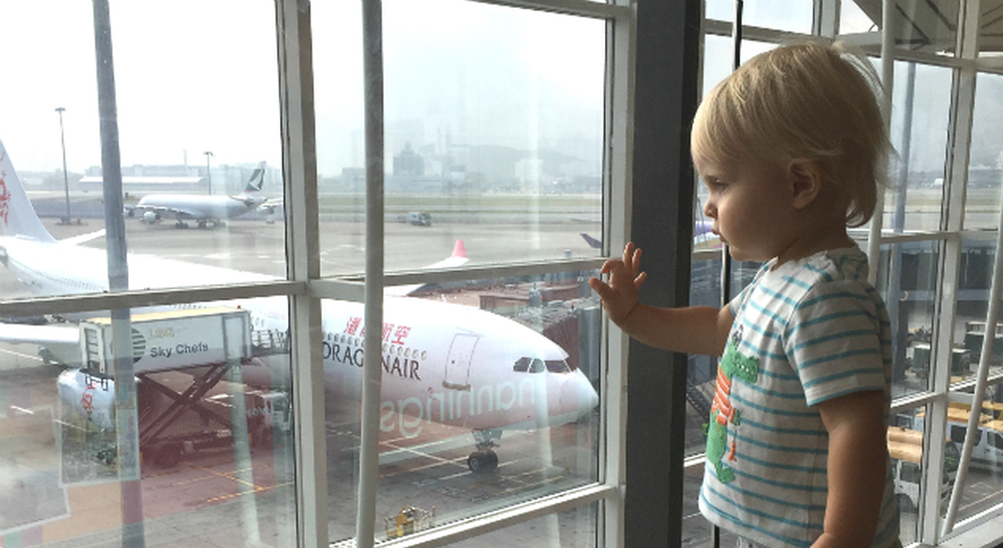 Boy watching planes at an airport