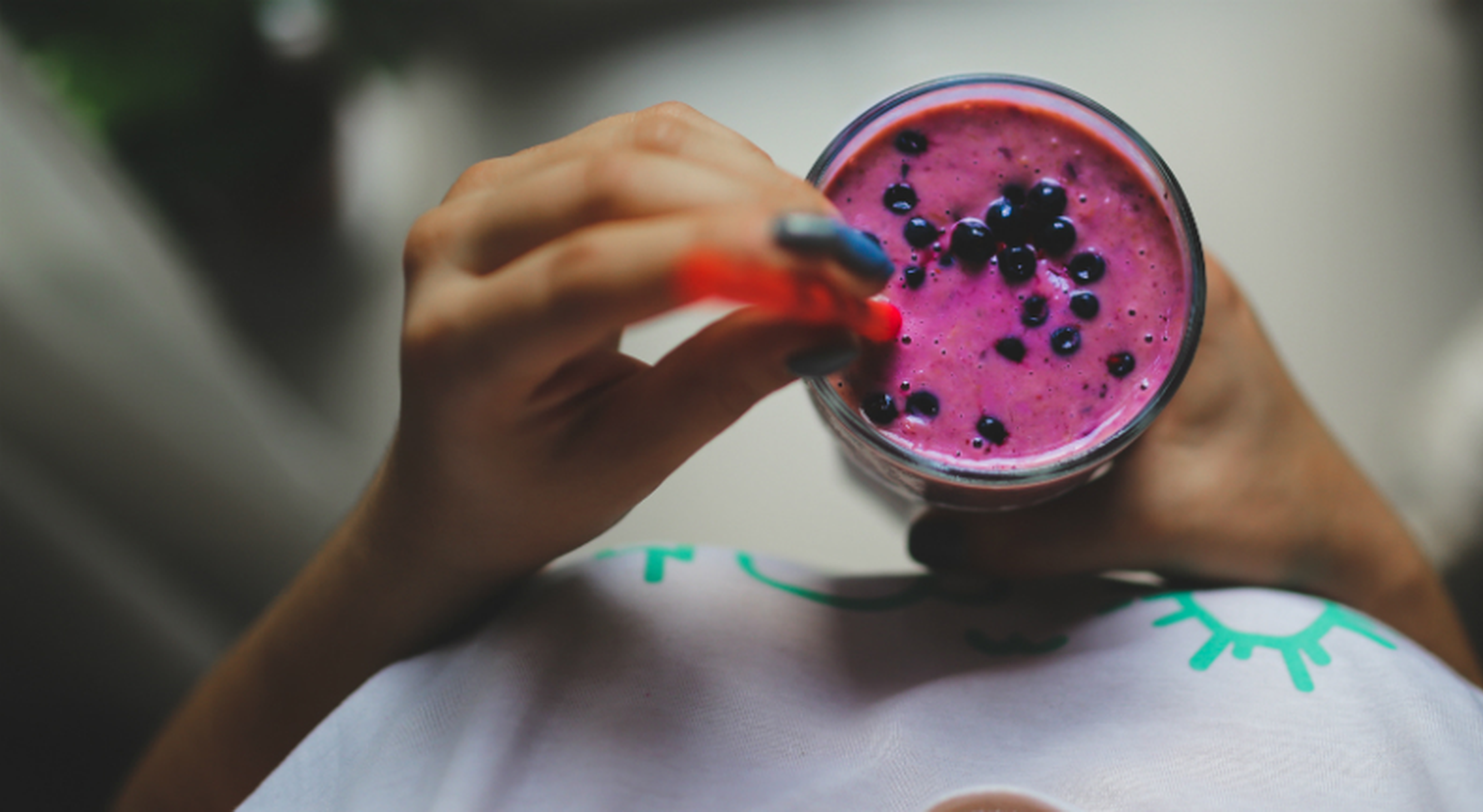 Woman drinking fruit smoothie