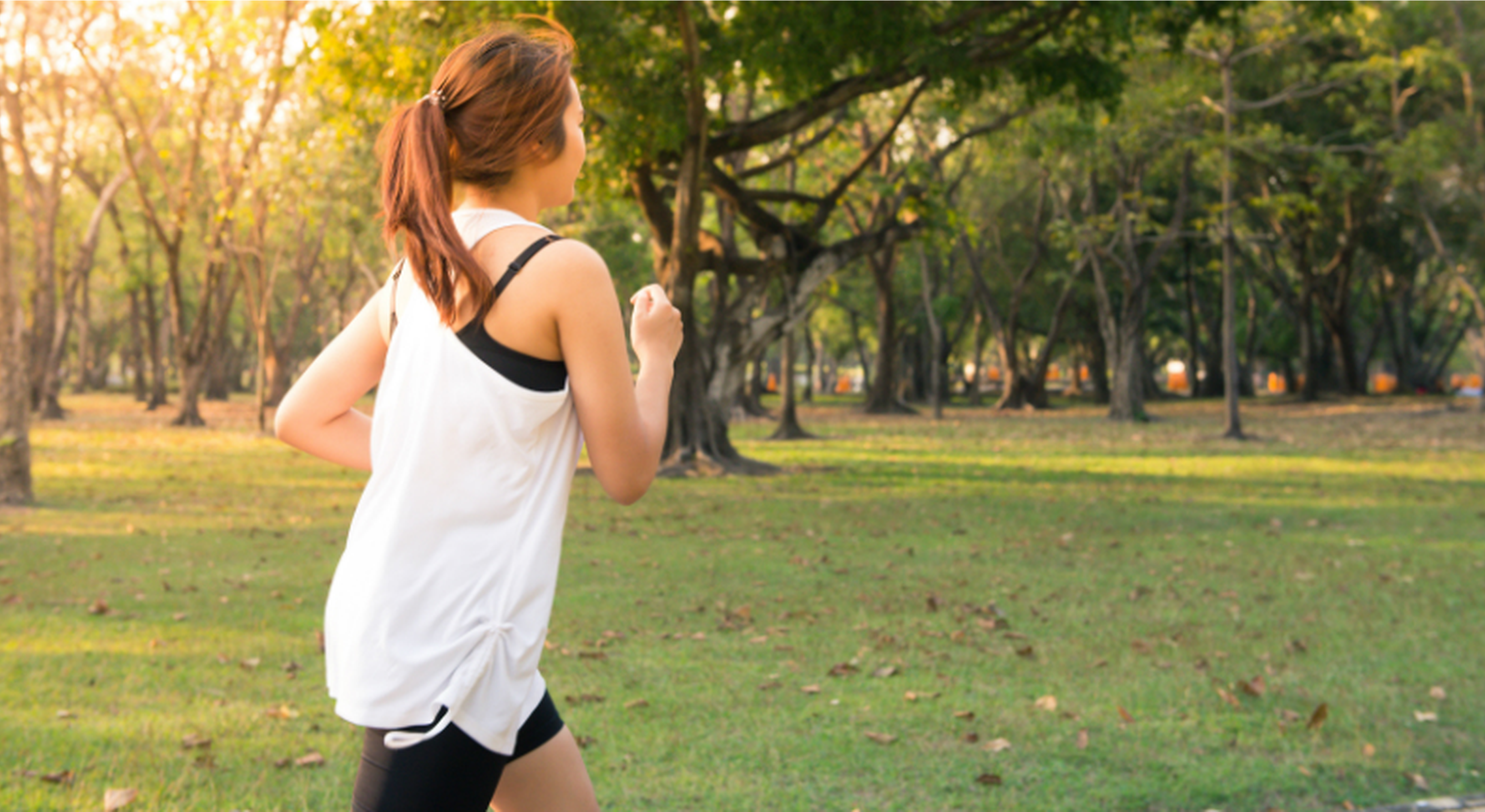 Woman jogging through park