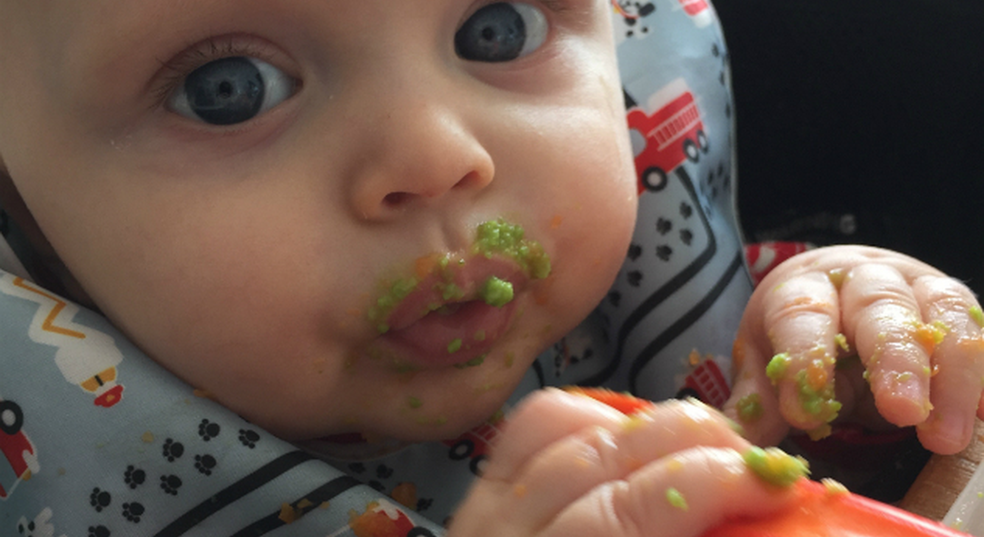 Baby trying first mouthfuls of food