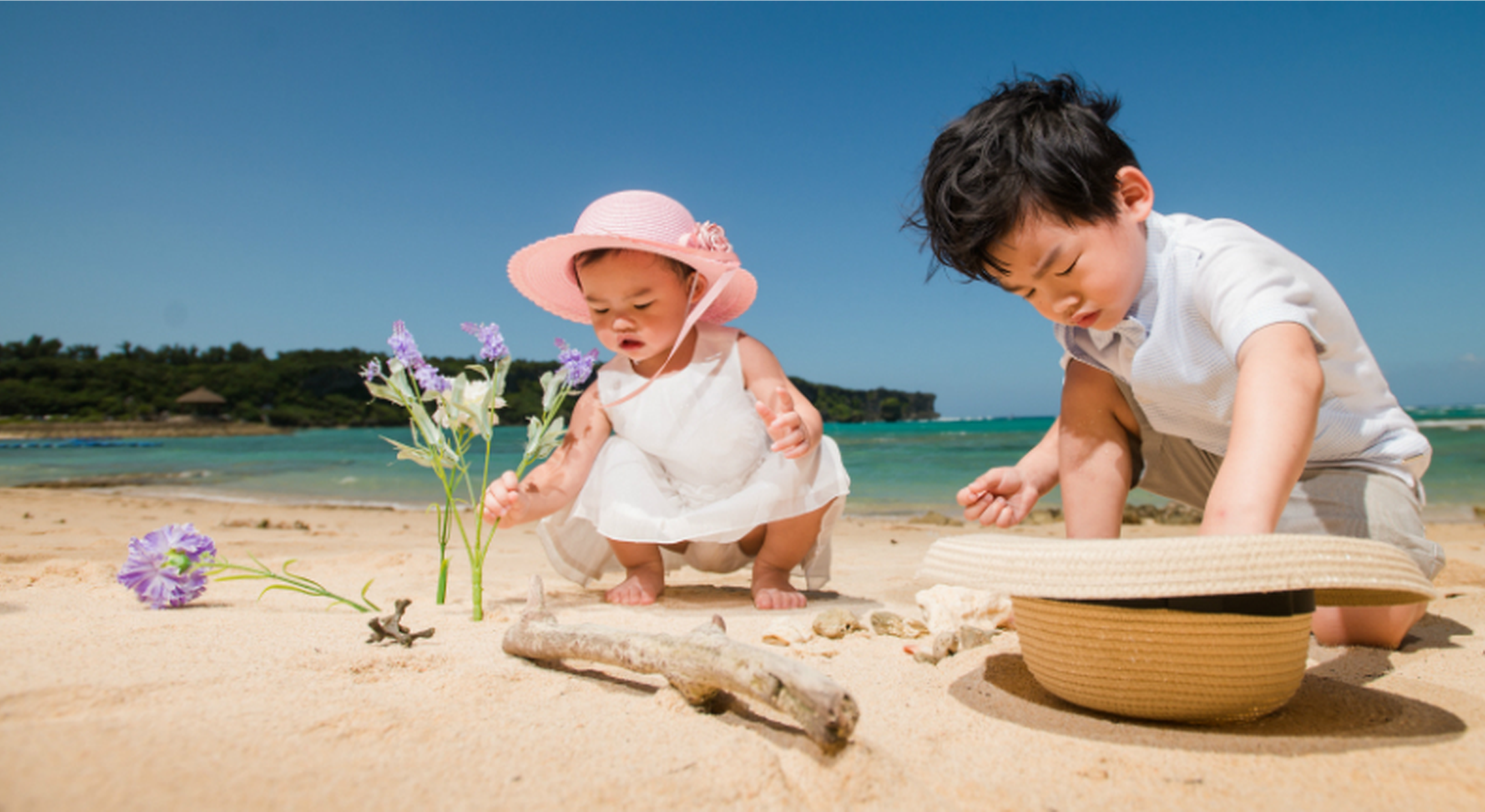 Boy and girl playing on the beach in the sun