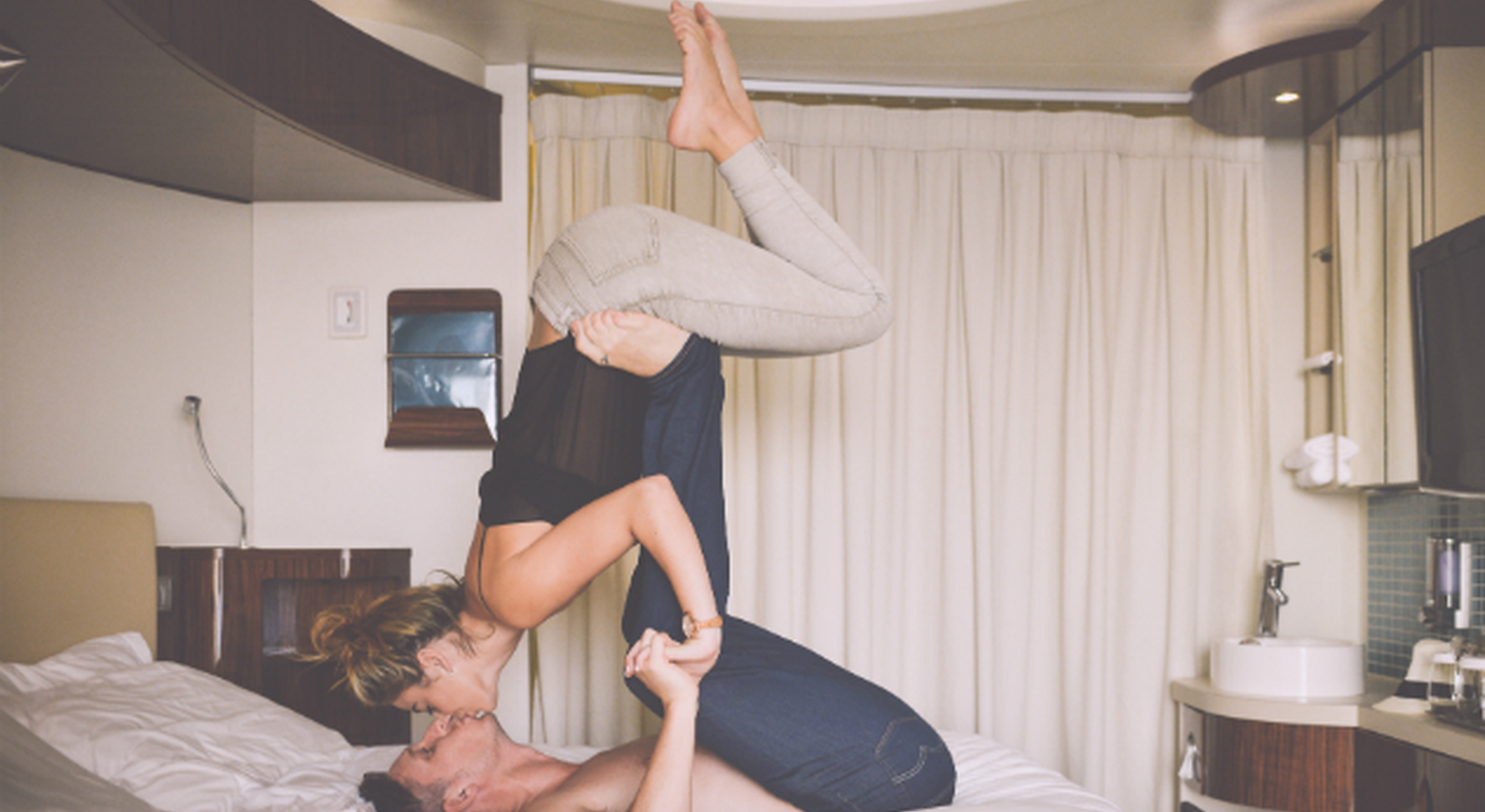 Couple doing yoga on a bed