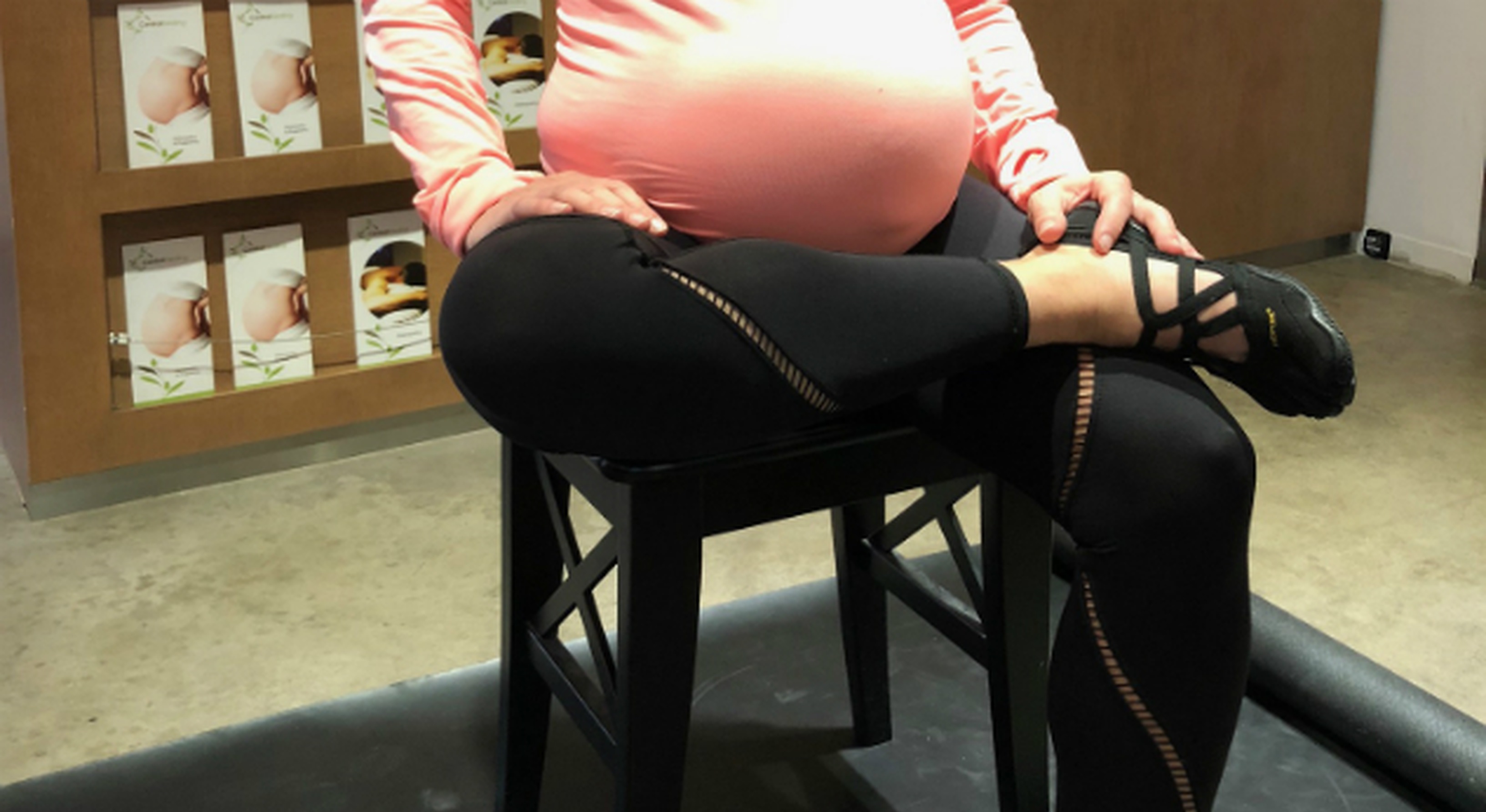 Pregnant woman performing glut stretches