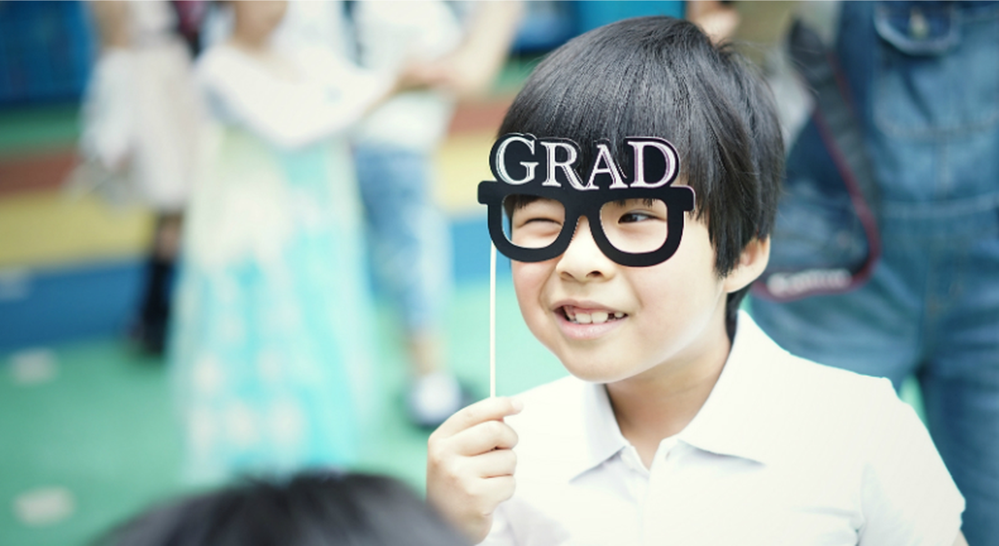 Child wearing joke graduation glasses