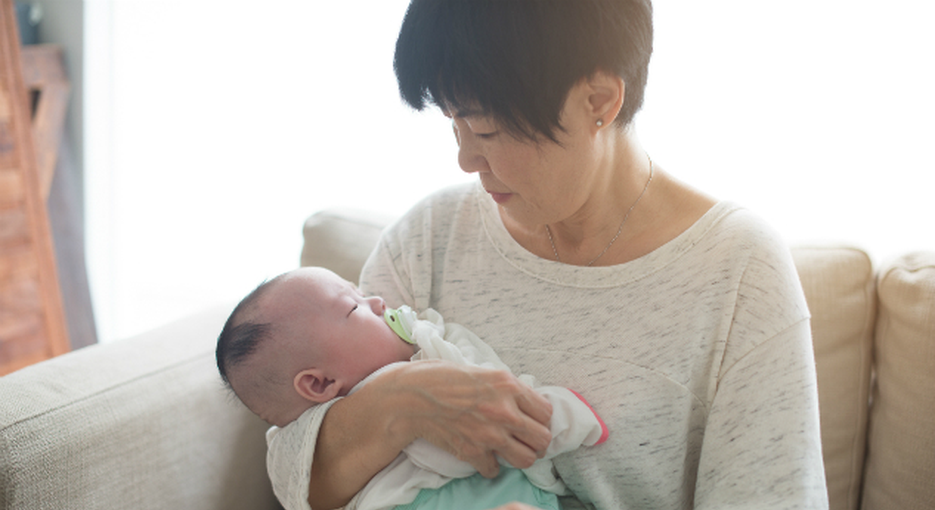 Nanny holding newborn baby