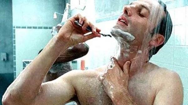 Man shaving in shower