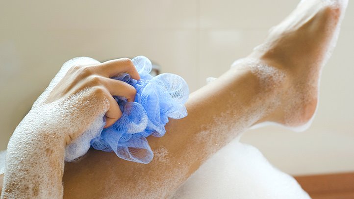 Using a scrub to exfoliate.